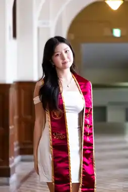 Graduation portrait in an arched hallway